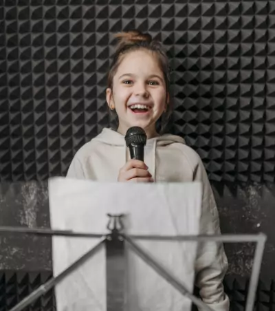 Girl sings using microphone for recording
